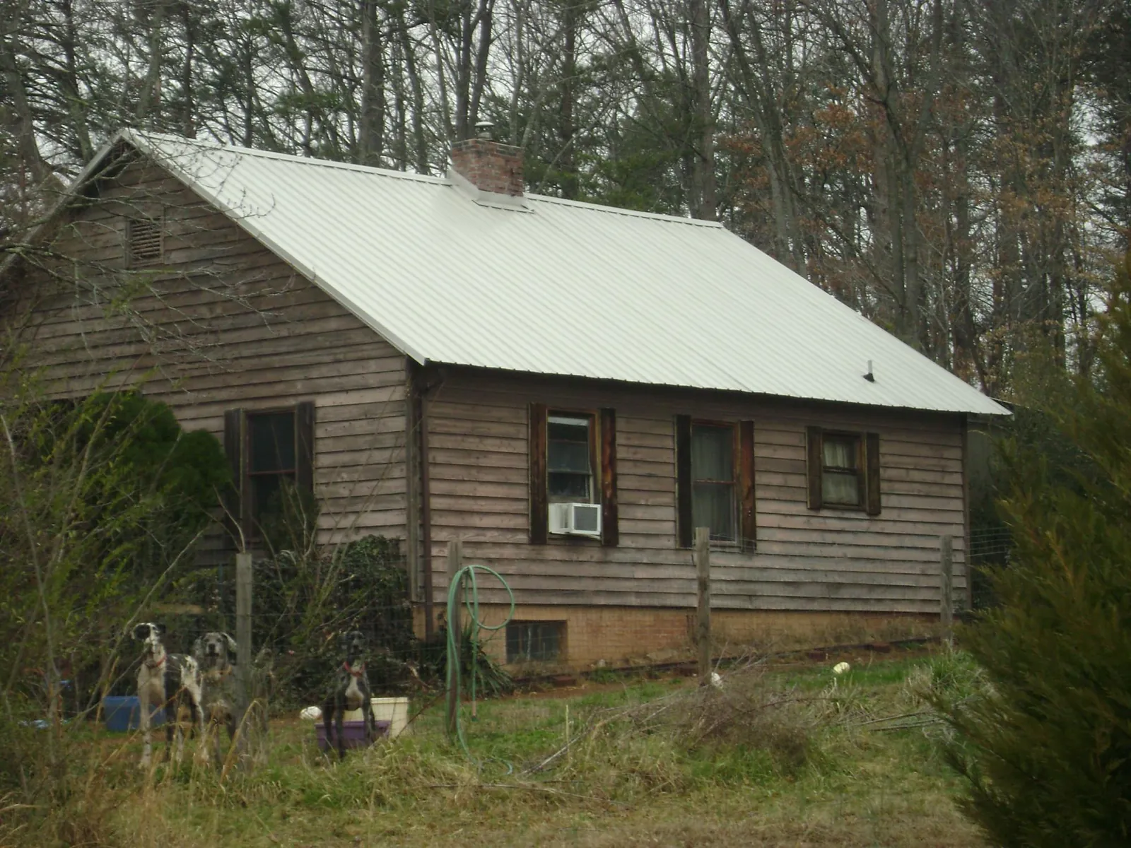 White metal roof on an old wood sided farmhouse, from a Metal Roof Installation job in Creal Springs